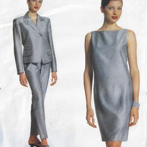 May include: A silver-grey two-piece suit consisting of a single-breasted blazer with notched lapels and matching trousers, alongside a sleeveless sheath dress in the same shimmering silver-grey fabric with a subtle textured pattern.