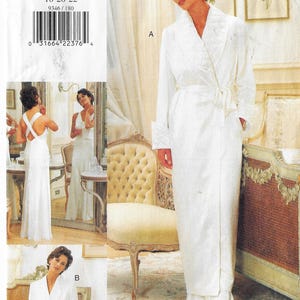 May include: A sewing pattern for a white robe with a shawl collar and a sash tie. The pattern includes instructions for making a matching slip dress with a criss-cross back.