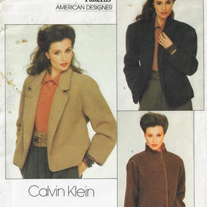 May include: A vintage fashion advertisement showcasing three jacket designs. The jackets are in shades of brown and black. The Calvin Klein logo is at the bottom, with "AMERICAN DESIGNER" at the top.