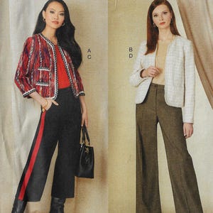 May include: Two women modeling outfits. One wears a red, black, and white patterned jacket, a red top, black pants with a red stripe, and carries a black handbag. The other wears a cream-colored jacket and brown pants.