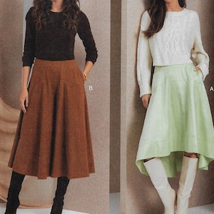 May include: Two women wearing different skirts. The woman on the left is wearing a brown skirt with a high waist and a flared silhouette. The woman on the right is wearing a light green skirt with a high waist and a high-low hemline.