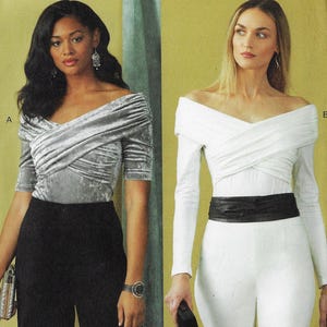 May include: Two off-the-shoulder tops. One is a silver-gray velvet with short sleeves, paired with black pants. The other is a white long-sleeve top with a black belt, worn with white pants. Both tops have a crossover design.