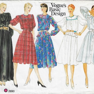 May include: A Vogue's Basic Design sewing pattern envelope featuring illustrations of five different dress styles. The designs include a black long-sleeve dress, a red plaid dress, a blue floral dress, a white dress, and a light blue striped dress.