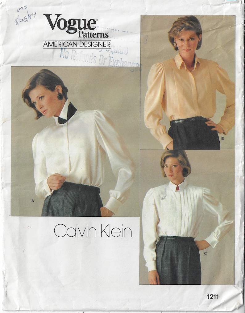 May include: A vintage sewing pattern for a white blouse with puffed sleeves. The pattern is by Vogue Patterns and designed by Calvin Klein. The pattern number is 1211.