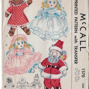 May include: Vintage McCall's sewing pattern 1570 for making three sock dolls, including a Santa, a girl in a pink dress, and a girl in a blue dress. The pattern is printed on paper and includes a transfer sheet. The pattern is for one size and is 35 cents.