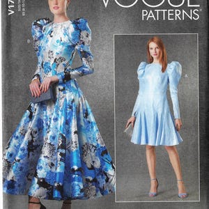 May include: Vogue Patterns sewing pattern featuring two dresses. One dress is a long, flowing gown with a blue floral print. The other is a short, light blue dress with long sleeves and a pleated skirt. The pattern includes the text "VOGUE PATTERNS".