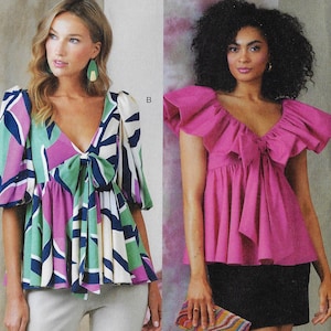 May include: Two women's tops. One is a colorful geometric print with a V-neck and bow. The other is a solid pink top with ruffled sleeves and a bow at the neckline. Both tops have a peplum style.