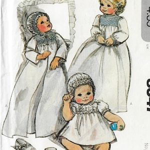 May include: Illustration of three babies in white dresses and bonnets. One baby is in a long gown with a bonnet and a ruffled edge. Another baby is in a long dress with a bonnet. The third baby is in a short dress and bonnet, holding a blue toy.