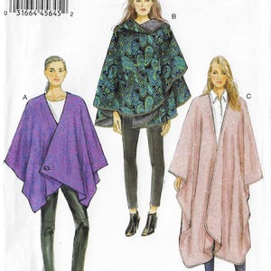 May include: Three women modeling different styles of capes. The capes are in purple, black with a paisley pattern, and pink. The purple cape has a button closure. The black cape has a hood. The pink cape is open in the front.