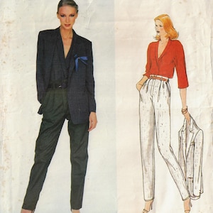 May include: A vintage fashion image showing two women. One is in a dark blue blazer, dark trousers, and a belt. The other wears a red top, white trousers, and holds a white blazer. The image is on a textured, off-white background.