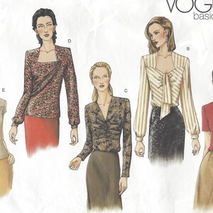 May include: Five different blouse designs with various necklines, sleeve lengths, and fabric patterns. The designs are labeled A through E.