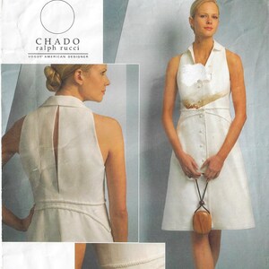 May include: A white sleeveless dress with a collared neckline and button-down front. The dress features a fitted waist and a flared skirt. The image also includes the text "CHADO ralph rucci" and "VOGUE AMERICAN DESIGNER".