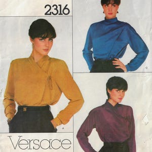 May include: A vintage sewing pattern for a women's blouse with a wrap style neckline. The pattern is for sizes 6-16 and includes three different views: a yellow blouse, a blue blouse, and a purple blouse. The pattern is from the brand Versace and has the number 2316 printed on it.
