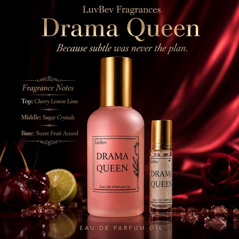 May include: A pink Drama Queen Eau de Parfum Oil bottle and rollerball with gold caps. The label includes the brand name LuvBev and fragrance notes: Cherry Lemon Lime, Sugar Crystals, and Sweet Fruit Accord. The background is a dark red.