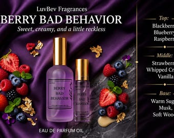 May include: Two glass bottles of LuvBev Fragrances Berry Bad Behavior eau de parfum oil with gold caps, surrounded by fresh strawberries, raspberries, blueberries, blackberries, mint leaves, and gold flakes on a purple fabric and marble surface.