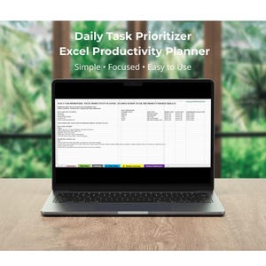 May include: A laptop displaying an Excel productivity planner titled "Daily Task Prioritizer." The screen shows a spreadsheet with various task categories and fields. The laptop sits on a wooden surface with a blurred green background.