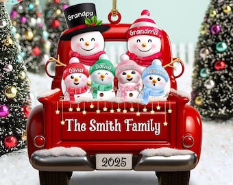 May include: A red Christmas ornament shaped like a vintage truck bed, carrying a snowman family. The ornament features the text "The Smith Family" and individual names. The year "2025" is displayed on the license plate. Snowmen wear hats and scarves.