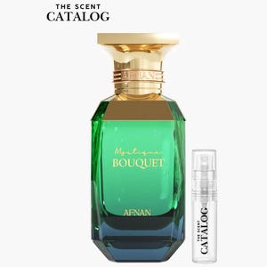 May include: A perfume bottle with a gold cap and a green, geometric-shaped body. The bottle is labeled "Mystique Bouquet" and "Afnan." A small sample vial is next to the bottle, with the text "The Scent Catalog."