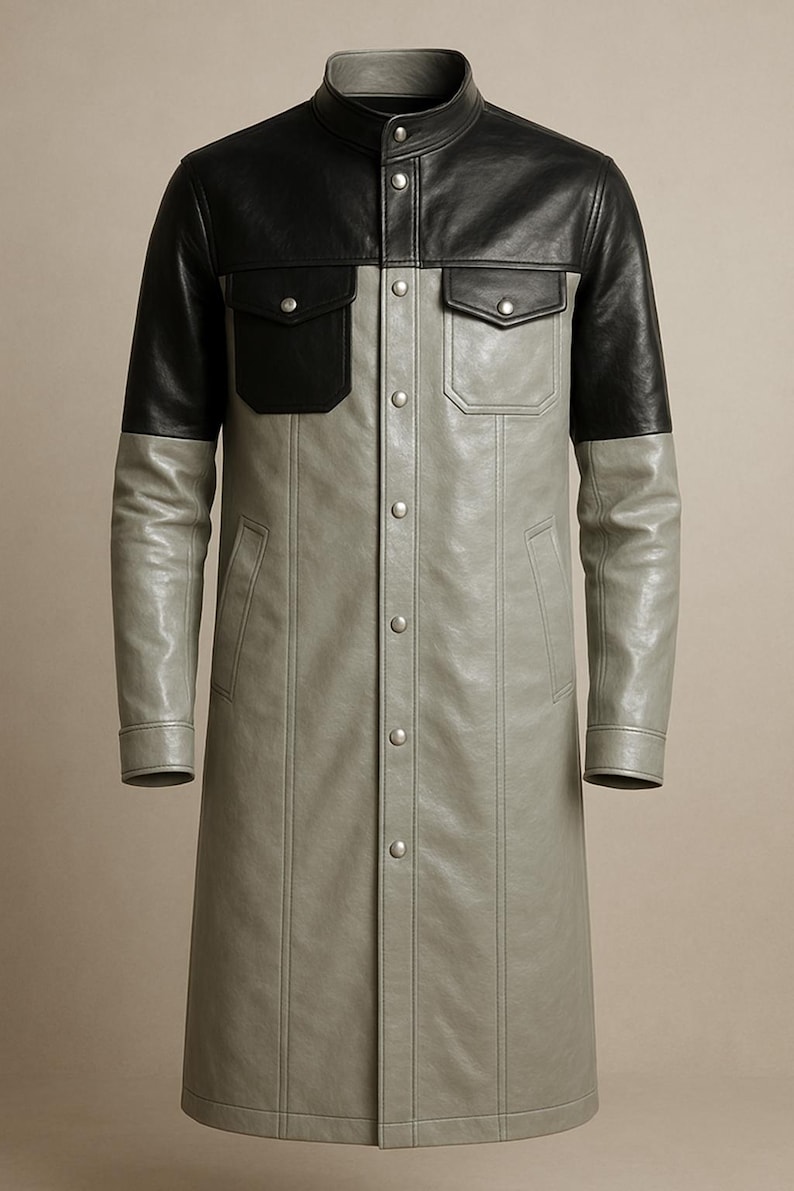 May include: A long, two-tone leather coat. The upper portion, including the sleeves and two chest pockets, is black. The lower portion is a light gray. The coat has a mandarin collar and is buttoned down the front.
