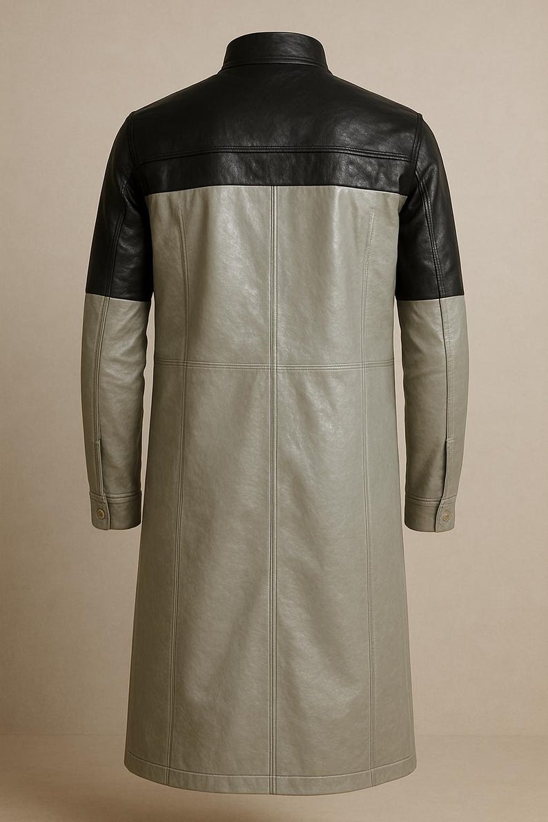 May include: A long, two-tone leather coat. The top yoke and sleeves are black, while the body is a light gray. The coat has a classic collar and buttoned cuffs. Vertical seams run down the front and back, adding structure to the design.
