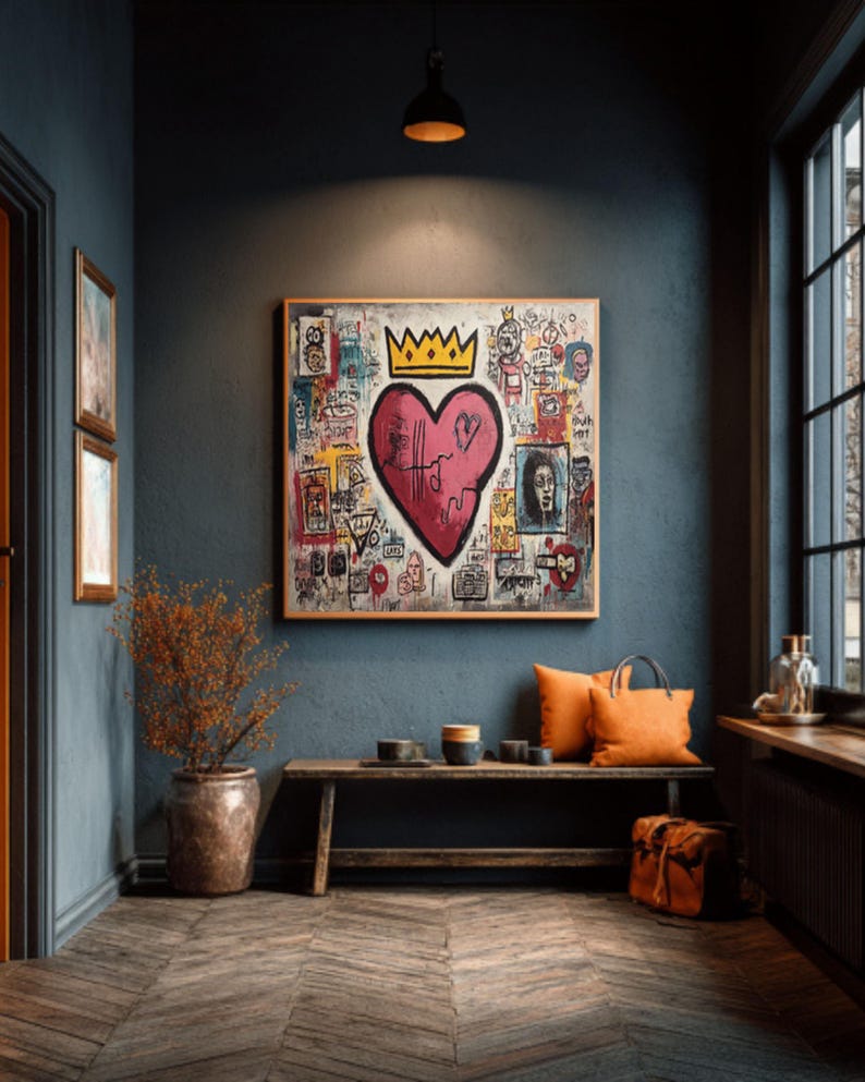 May include: A framed artwork featuring a large pink heart with a gold crown, surrounded by colorful graffiti-style drawings. The artwork hangs above a wooden bench with orange pillows and a leather bag. The room has dark blue walls and a wooden floor.