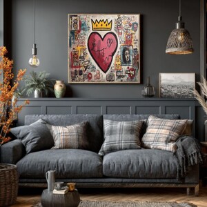 May include: A living room scene featuring a gray sofa with plaid and solid throw pillows, a woven rug, and a dark wood coffee table. A large framed artwork with a heart and crown design hangs above the sofa. Decorative lamps and plants complete the cozy interior.