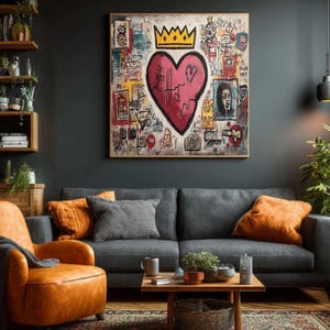 May include: A large framed artwork featuring a red heart with a crown, set against a background of graffiti-style drawings and text. The artwork hangs above a gray sofa with orange pillows, complemented by an orange leather armchair and a wooden coffee table.