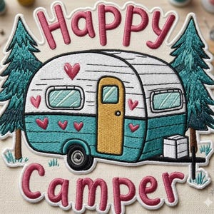 May include: Embroidered patch featuring a teal and white camper with a yellow door, surrounded by two green pine trees. The patch reads "Happy Camper" in pink script with a white outline, and includes pink hearts. The patch is on a beige background.