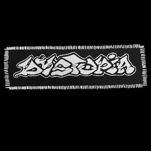 May include: Black rectangular patch with white text that reads "ASAPIA" in a stylized font. The patch has a white border made of short vertical lines. The background is solid black.