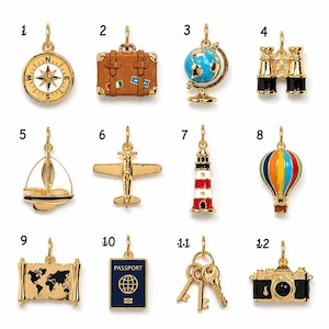 May include: A collection of twelve gold-toned metal charms featuring travel-themed designs including a compass, suitcase, globe, binoculars, sailboat, airplane, lighthouse, hot air balloon, map, passport, keys, and a camera, each with a jump ring.