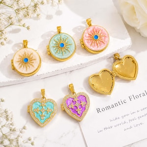May include: A collection of gold-tone metal pendants including three circular lockets with sunburst designs in white, mint green, and pink enamel, and two heart-shaped lockets with filigree cross patterns in turquoise and purple enamel.