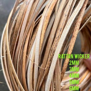 May include: Close-up of rattan wicker strands in varying shades of brown and tan. The image displays the text "RATTAN WICKER" and measurements: 2MM, 3MM, 4MM, 5MM, and 6MM. The natural material is tightly woven.