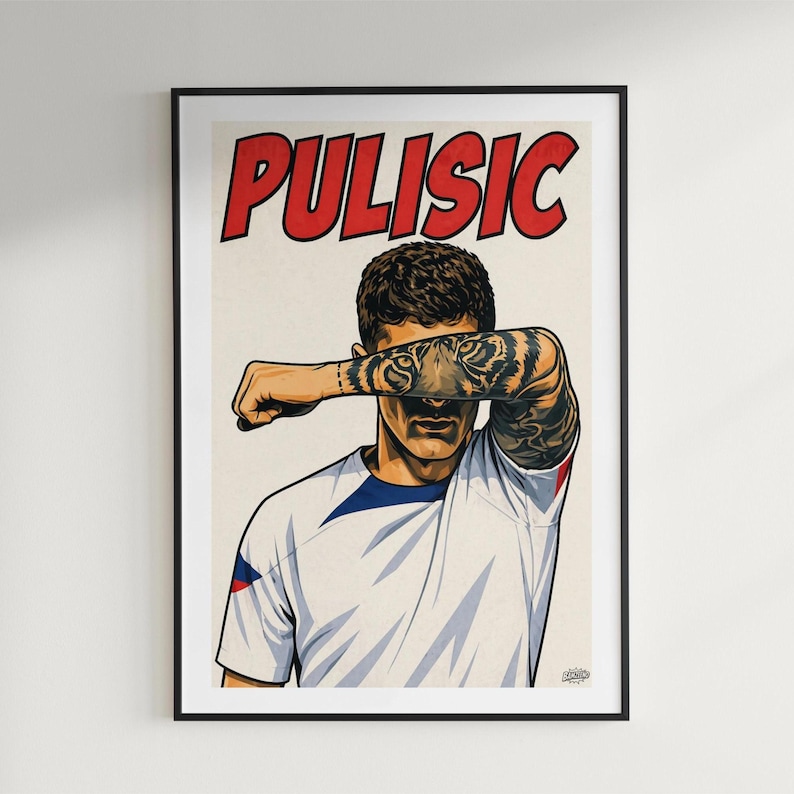 May include: A framed poster featuring a stylized illustration of a soccer player with a tiger tattoo on the forearm covering the eyes. The name PULISIC is printed in large red letters at the top. The player wears a white jersey with blue accents.