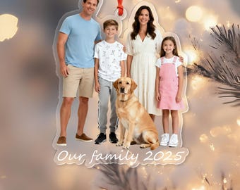 May include: A clear acrylic ornament featuring a family portrait with a golden Labrador. The family of four is outlined in a clear border, with the text "Our family 2025" at the bottom. A red ribbon is attached for hanging.