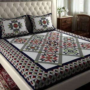 May include: A bed with a white headboard and a patterned quilt and pillow set. The quilt features a geometric star design in red, green, gray, and white. The pillows have a similar star pattern. The bedspread has a dark blue border.