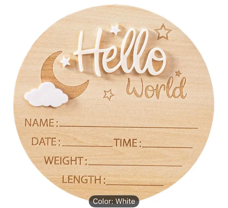 May include: A round wooden baby announcement sign with the words "Hello World" in white script. The sign includes a crescent moon, stars, and a cloud. It has spaces to write the baby's name, date, time, weight, and length.