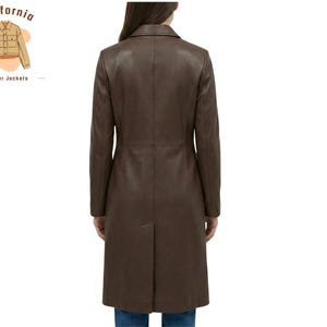 May include: A brown leather coat with a notched collar and a long, tailored silhouette. The coat extends to the knees and features a back vent. The California Leather Jackets logo is in the upper left corner.