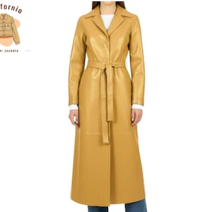 May include: A long, mustard-yellow leather trench coat with a belted waist and button closure. The coat has a classic lapel collar and long sleeves. The image also includes the text "California leather jackets".
