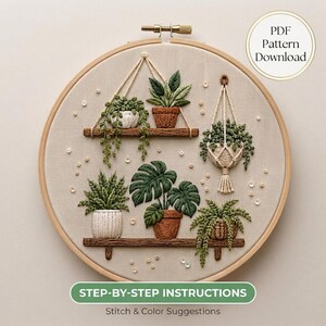 May include: An embroidery hoop containing a fabric panel with stitched illustrations of various potted plants on shelves and in macrame hangers. The text PDF Pattern Download and STEP-BY-STEP INSTRUCTIONS Stitch & Color Suggestions are visible.