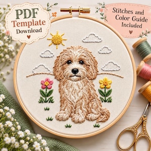 Puede incluir: Un bastidor de bordado que contiene un panel de tela con un diseño bordado de un cachorro marrón claro sentado en un campo con un sol amarillo, nubes blancas y dos flores. El texto dice PDF Template Download y Stitches and Color Guide Included.
