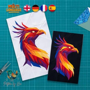 May include: Two rectangular fabric quilt blocks featuring a geometric phoenix design. One block has a white background, and the other has a black background. The phoenix is composed of angular, multi-colored segments in shades of red, orange, yellow, purple, and blue.