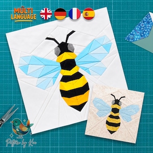 May include: A foundation paper piecing quilt block pattern featuring a geometric bee with black and yellow striped body, grey head, and light blue wings on a white background, alongside a smaller version on a beige patterned fabric background.