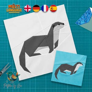 May include: A foundation paper piecing quilt block pattern featuring a geometric otter design. The large block is white with a dark gray otter, while the smaller block is light blue with a dark gray otter. Includes text "MULTI LANGUAGE".