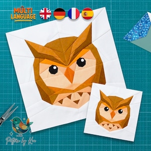 May include: Two white fabric squares with owl designs. The larger square features a detailed owl face in shades of brown and orange. The smaller square shows a similar owl design. The image includes the text "MULTI LANGUAGE" and "Pattern by Kia".
