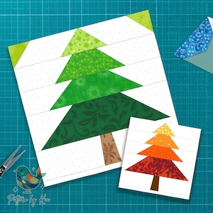 Könnte beinhalten: Zwei Weihnachtsbaum-Quiltblöcke, einer groß und einer klein, mit grünen und orangen Baumdesigns. Der größere Baum hat einen braunen Stamm und befindet sich auf einem weißen Hintergrund mit einem gepunkteten Muster. Eine Schere und ein Vogellogo sind im Bild.