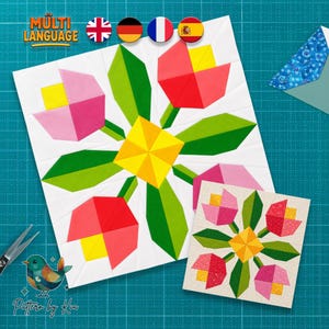 May include: Two floral quilt blocks with a geometric design. The larger block features red, pink, yellow, and green shapes arranged in a flower pattern. The smaller block has a similar design. The image includes the text "MULTI LANGUAGE" and "Pattern by Kia".
