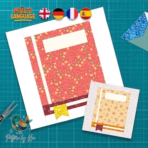 May include: Two fabric book-themed quilt blocks. The larger block features a red floral pattern, a white rectangle, and a yellow bookmark. The smaller block has a yellow floral pattern. The image includes the text "MULTI LANGUAGE" and a logo.