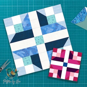 Pode incluir: Dois blocos de colcha, um grande e outro pequeno, com um esquema de cores azul e branco. O bloco maior apresenta um design de estrela com várias tonalidades de azul e quadrados brancos. O bloco menor tem um design semelhante em rosa e roxo.