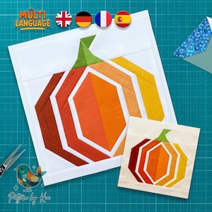 May include: A quilt block pattern featuring a stylised pumpkin design constructed from fabric strips in shades of dark red, orange, and yellow, with a green stem, set against a white background, accompanied by a smaller version of the same design.