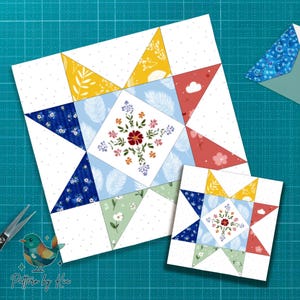 Könnte beinhalten: Zwei sternförmige Quiltblöcke mit Blumen- und Blättermustern in Blau-, Gelb-, Rot- und Grüntönen. Die Blöcke befinden sich auf einer grünen Schneidematte. Der Text "Pattern by Kia" befindet sich in der unteren linken Ecke.